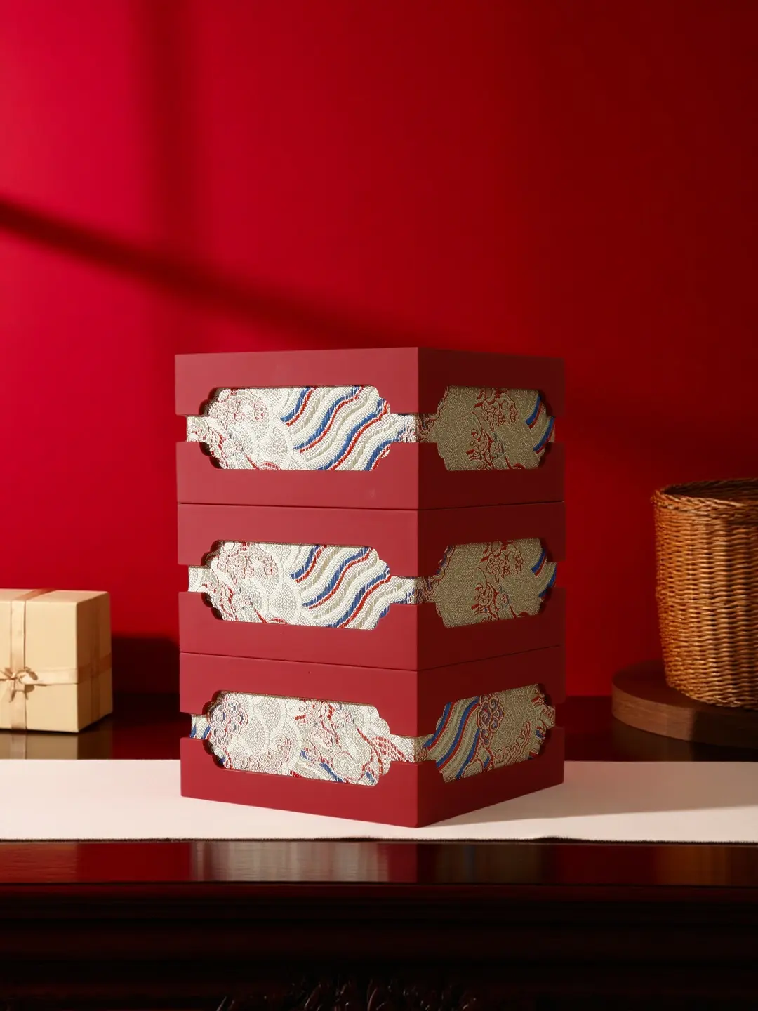 Three Chinese festive jewelry gift boxes stacked, showing brocade side-wrap detail