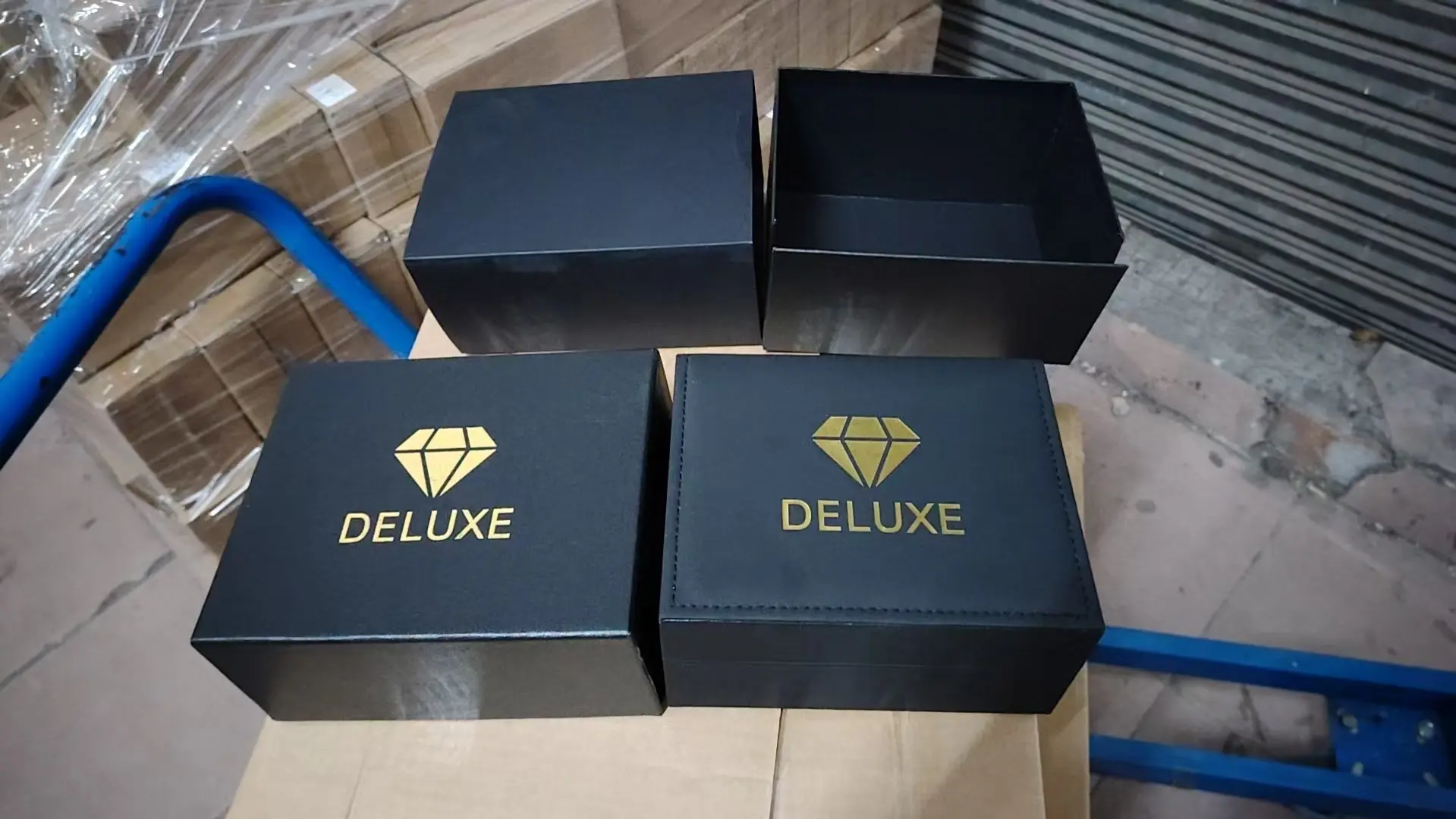 PU leather watch boxes in factory production with custom DELUXE logo hot-stamped on lid