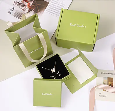 Green branded jewelry packaging set with paper bag and box
