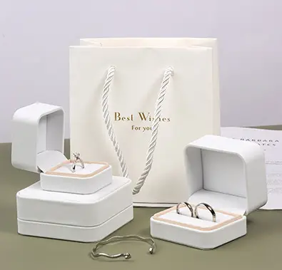 White jewelry packaging boxes and matching bag