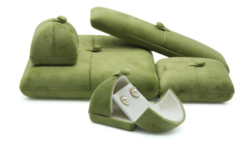 velvet vs leatherette jewelry boxes — green velvet box set with soft pile holding gold earrings