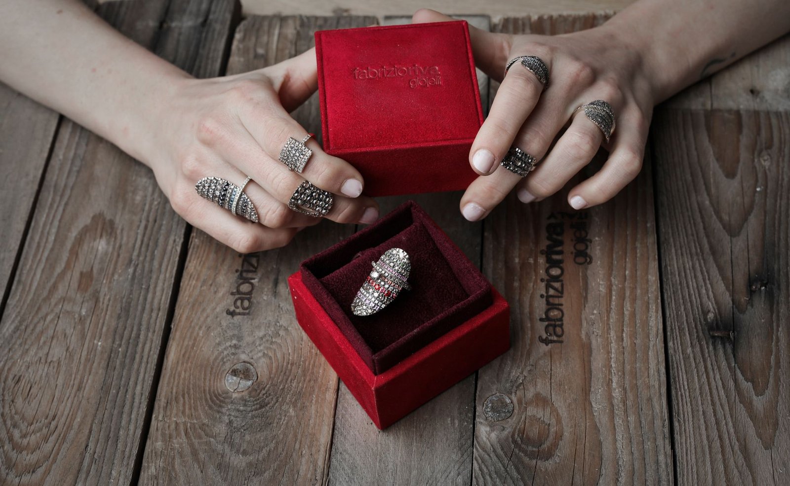 custom jewelry boxes with logo — rings in a velvet jewelry box showing a soft-touch material finish
