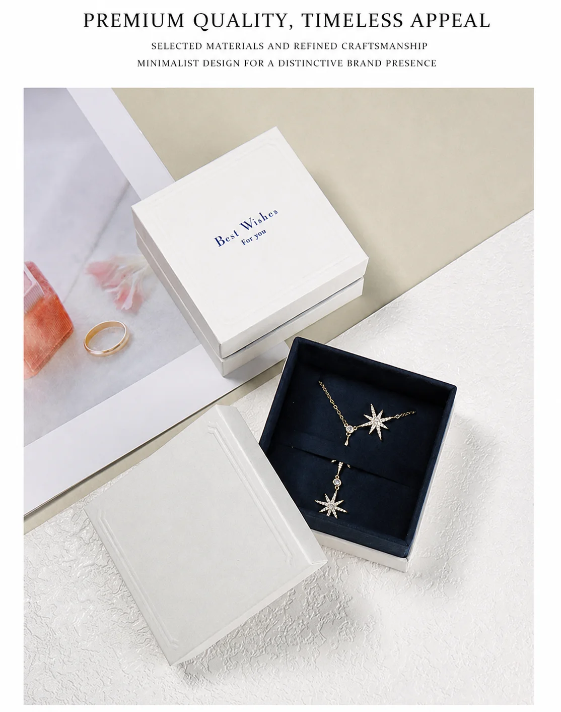 White specialty-paper pendant jewelry box with navy flannel insert displaying a matching star necklace and earrings