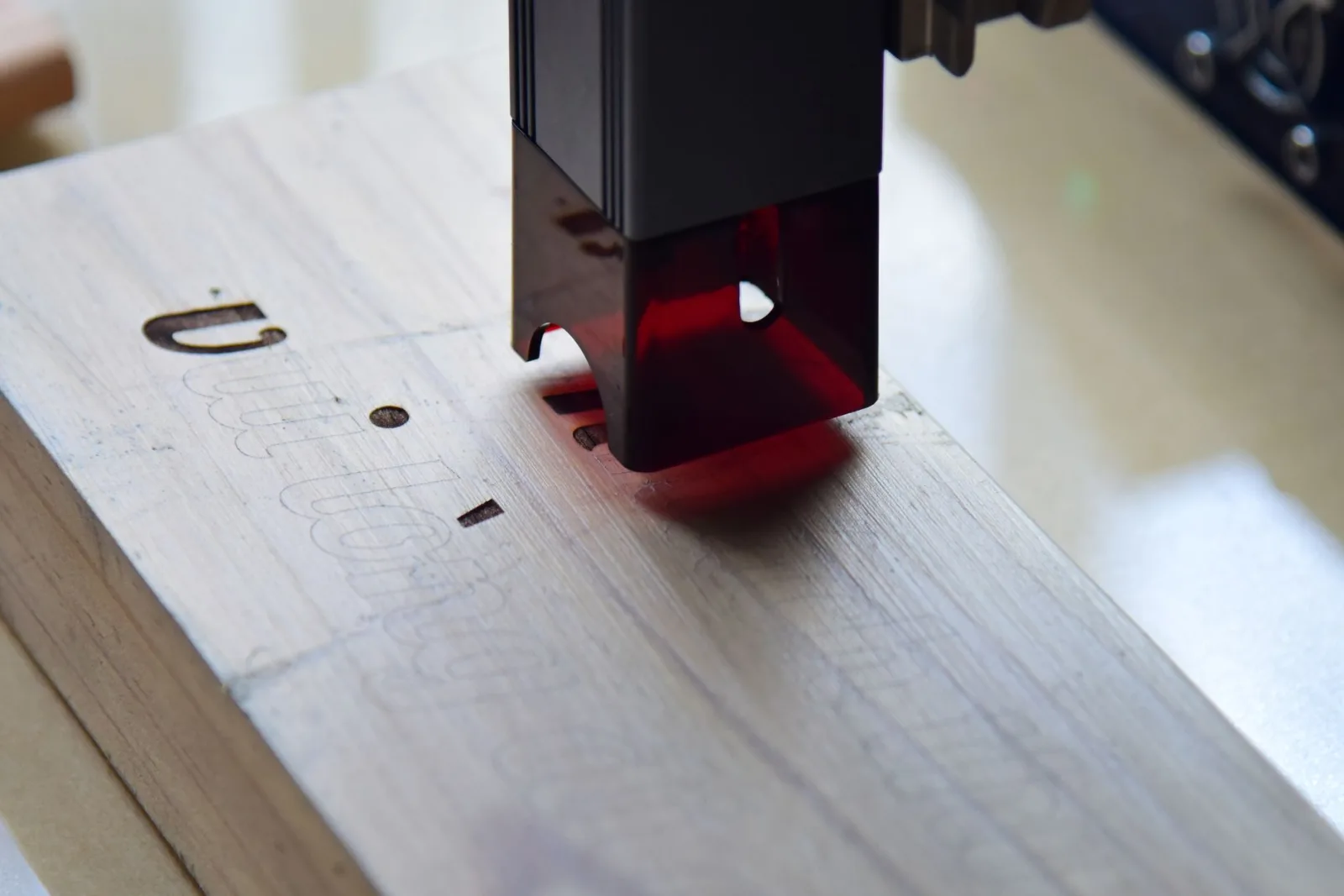 Laser engraving process on a natural wood surface