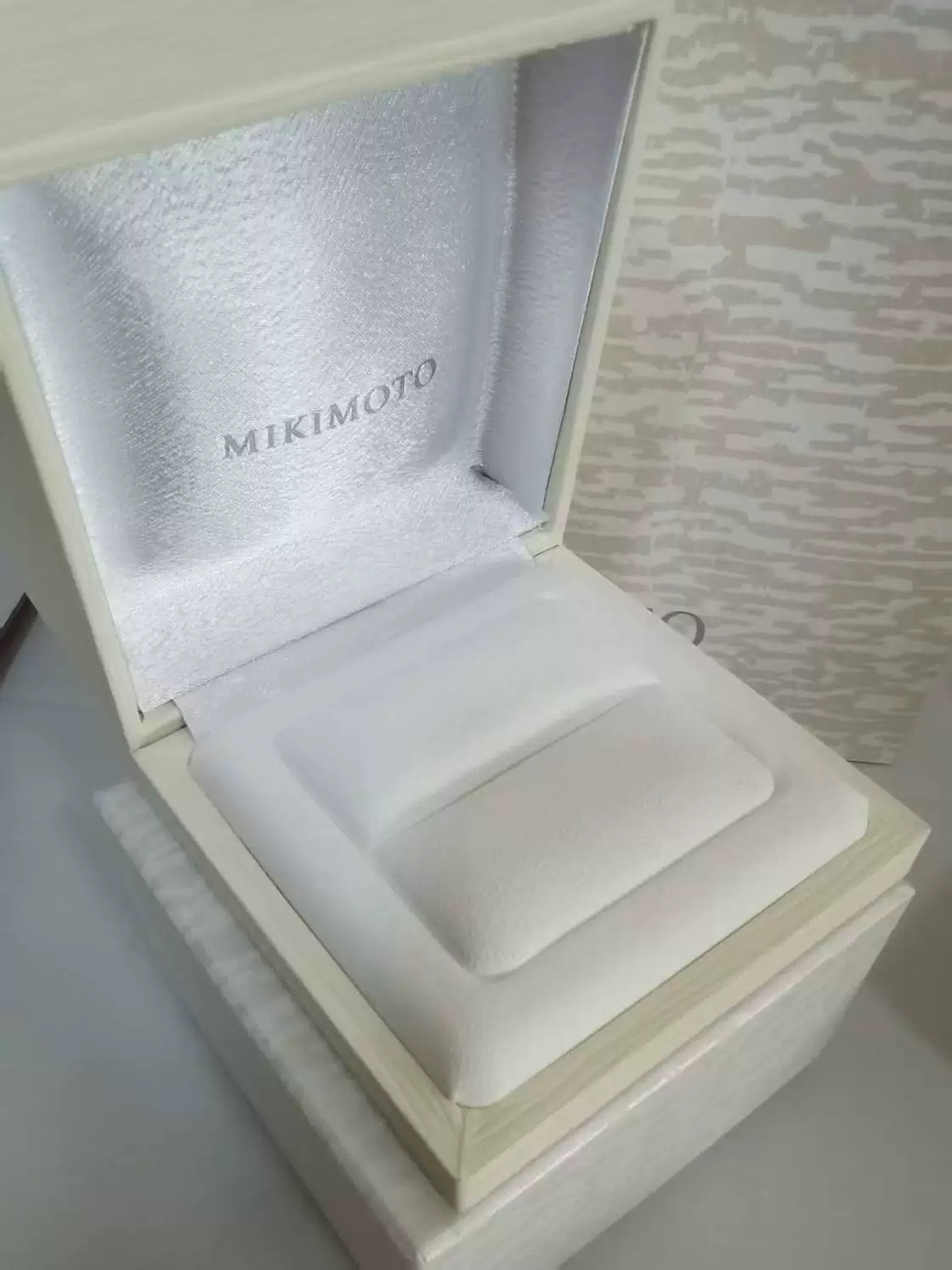 White MIKIMOTO sample jewelry box open, showing the lustrous velvet lining and soft microfiber insert